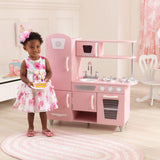 KidKraft Vintage Wooden Play Kitchen – Pink Retro Design, Working Knobs & Toy Phone
